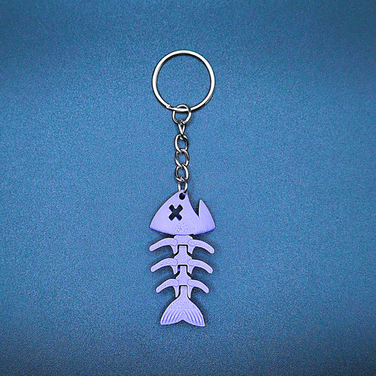 Purple articulated fish keychain featuring connected segments for movement, handmade from PLA plastic for fun fidget or aquatic gifting.
