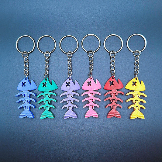 Six articulated fish keychains in assorted colors, featuring wiggly segments for sensory play, perfect as gifts for ocean lovers or fishermen.