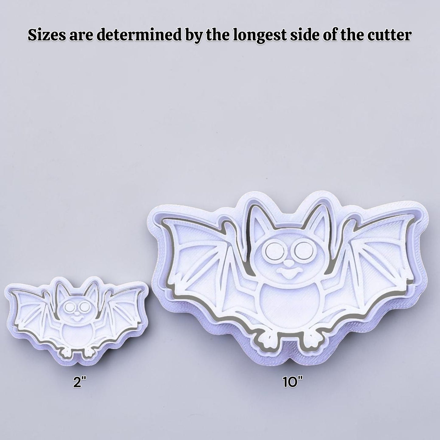 Halloween bat cookie cutters side by side to illustrate how sizing from 2 inches to 10 inches works.