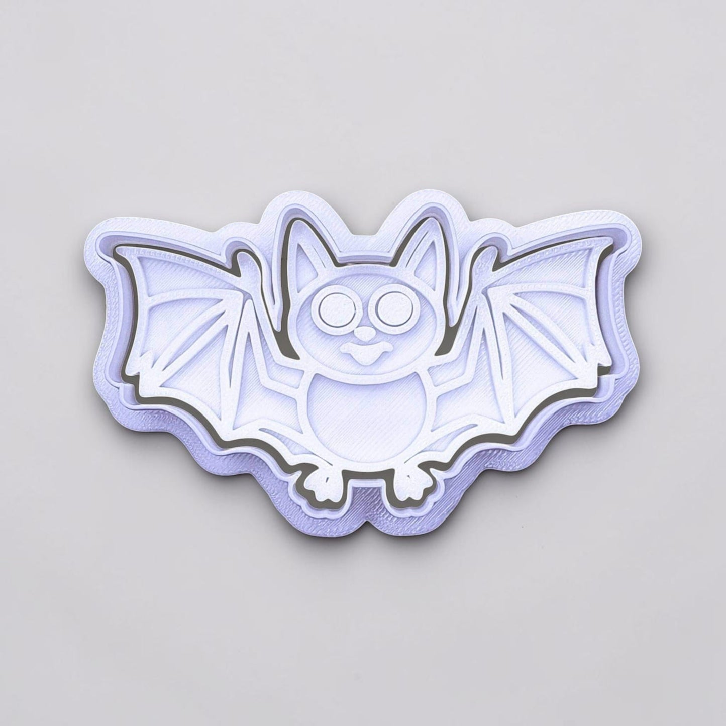 Close-up of bat cookie cutter with matching stamp, perfect for spooky Halloween cookies, fondant crafts, and gothic-themed baking projects.