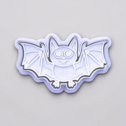 Close-up of bat cookie cutter with matching stamp, perfect for spooky Halloween cookies, fondant crafts, and gothic-themed baking projects.