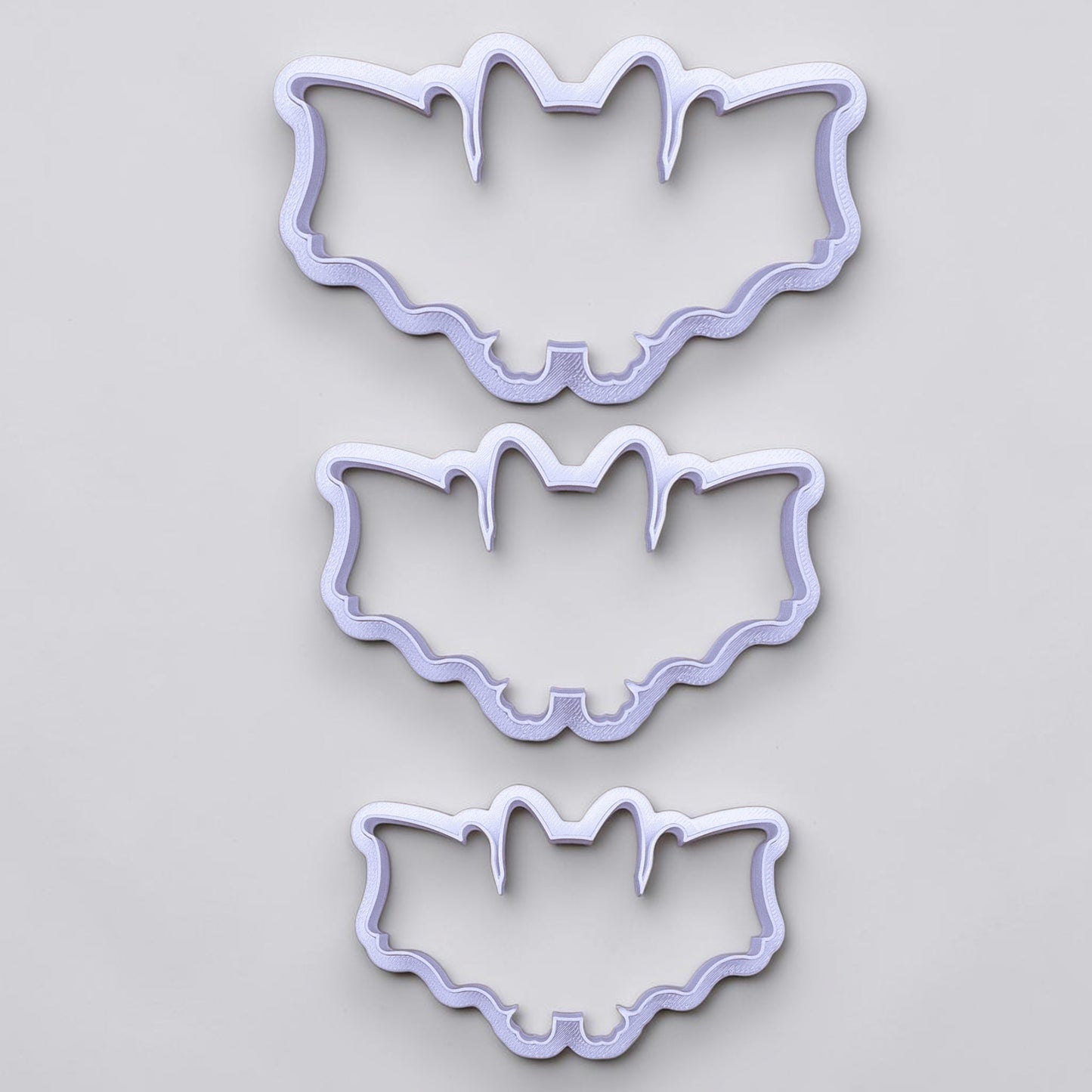 Set of three bat cookie cutters in small, medium, and large sizes for versatile Halloween and spooky cookie baking.