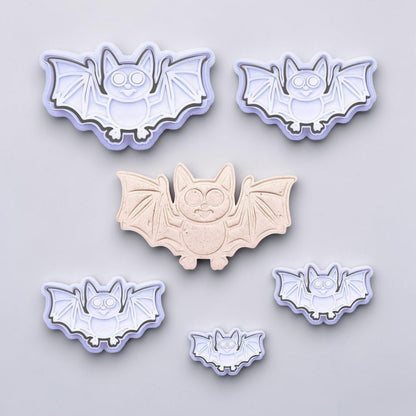 Set of bat-shaped cookie cutters on a light gray background