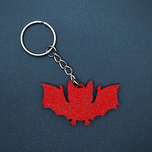 Front view of red bat keychain, handmade eco-friendly Halloween key ring, spooky gothic bag charm, and vampire-themed gift accessory.