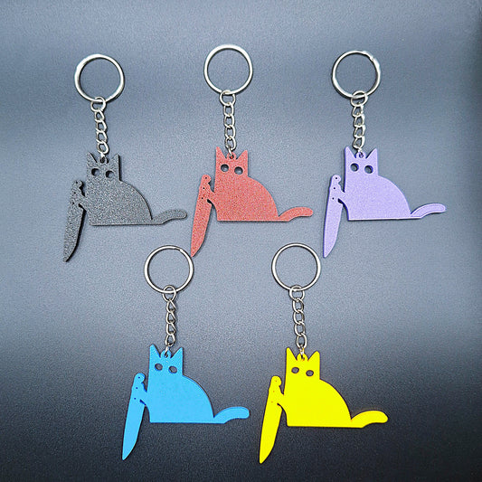 Close-up of five black cat knife keychains in assorted colors, showcasing detail and custom color options for creepy cute key rings.
