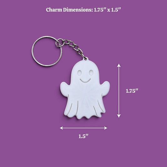White ghost-shaped keychain charm with a silver metal split ring and chain, shown on a purple background with dimension labels indicating 1.75" x 1.5"