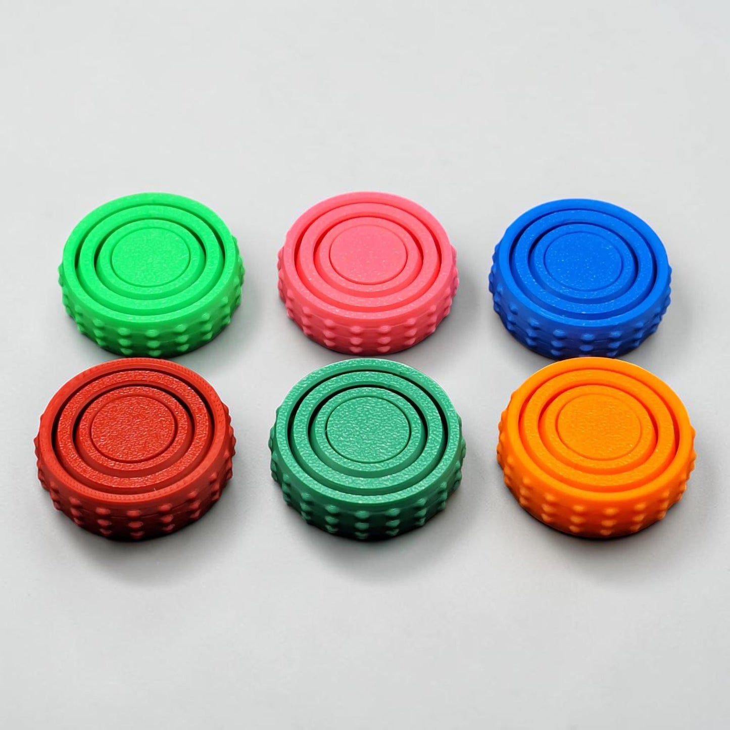 Bulk fidget and gyro spinners in six colors, perfect for party favors, event giveaways, classroom prizes and promotional items. Customizable in 30 colors and handmade in USA.