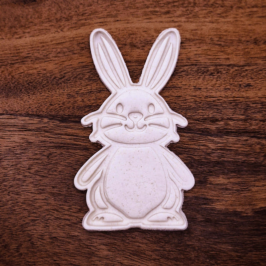 Cookie dough cutouts of a cute rabbit with stamped ear, paw, and tail detail. Great for decorating, fondant, and spring crafts.