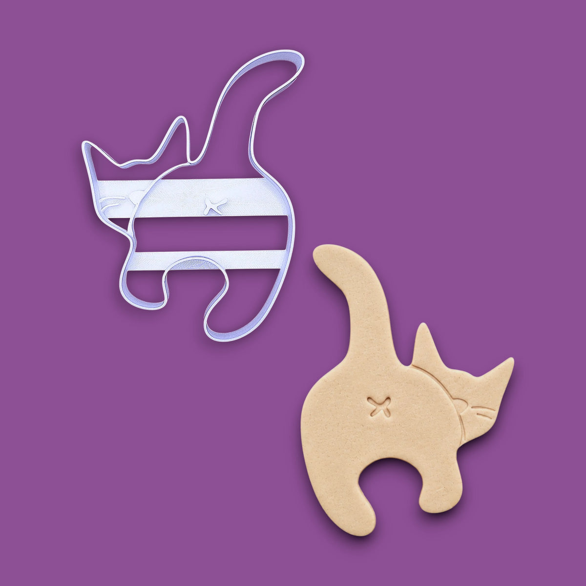 Cat butt cookie cutter alongside a dough cutout and imprint, perfect for gag gifts, funny treats and white elephant parties.