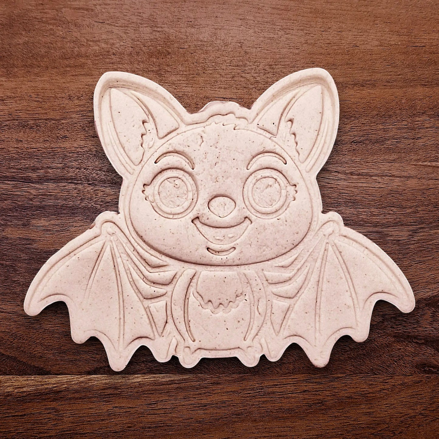 Stamped cute bat cookie dough with cute details from cutter and stamp set—perfect for cute and spooky Halloween bakes without the need for piping.