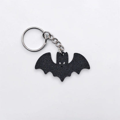 Handmade and customizable bat keychain in black, perfect for Halloween gifts, party favors, or gothic-themed keyring collections.