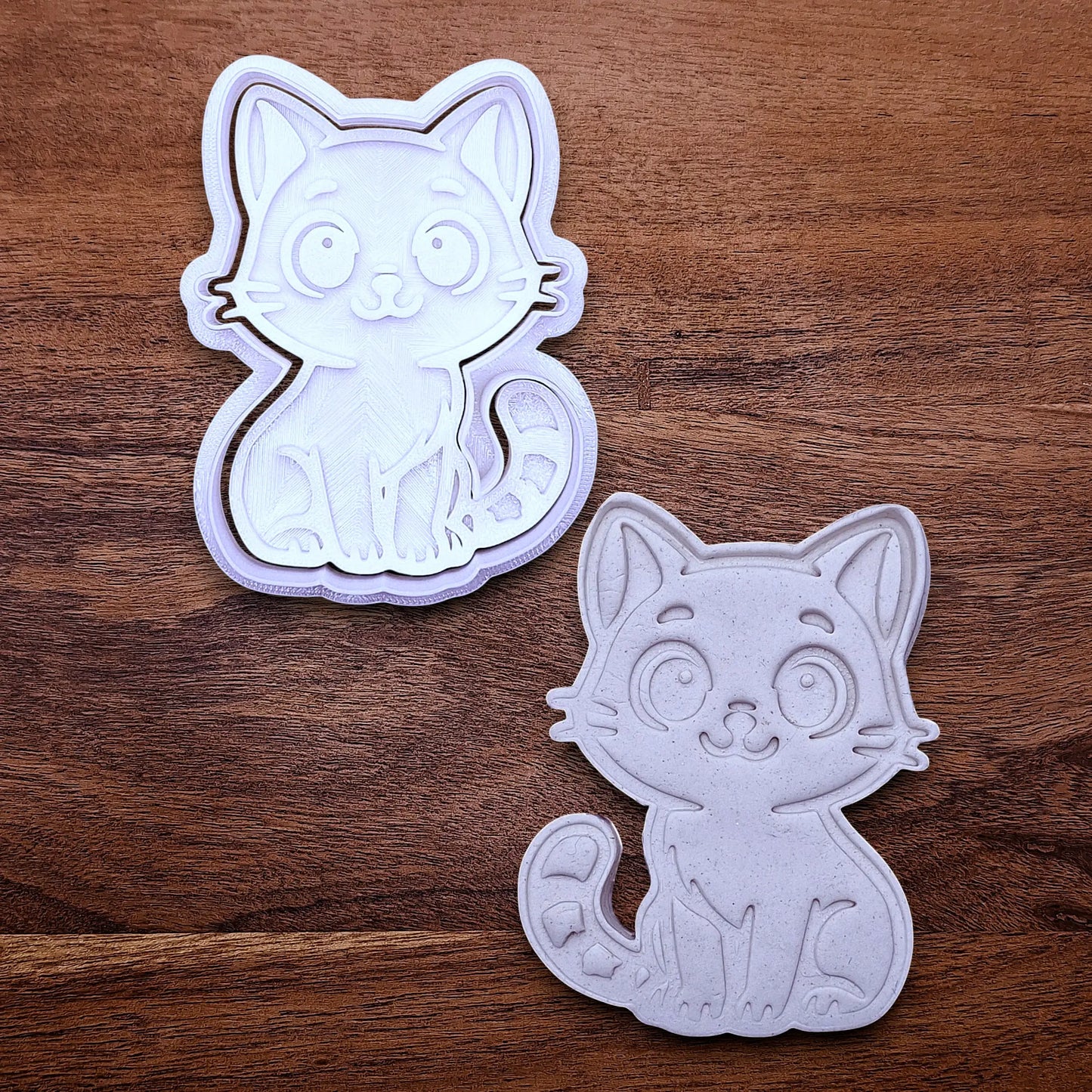 Customizable cat cookie cutter and stamp alongside a cat dough cutout and imprint, perfect for kitty cookie designs, fondant toppers, birthday parties, crafts or cat themed baking projects.