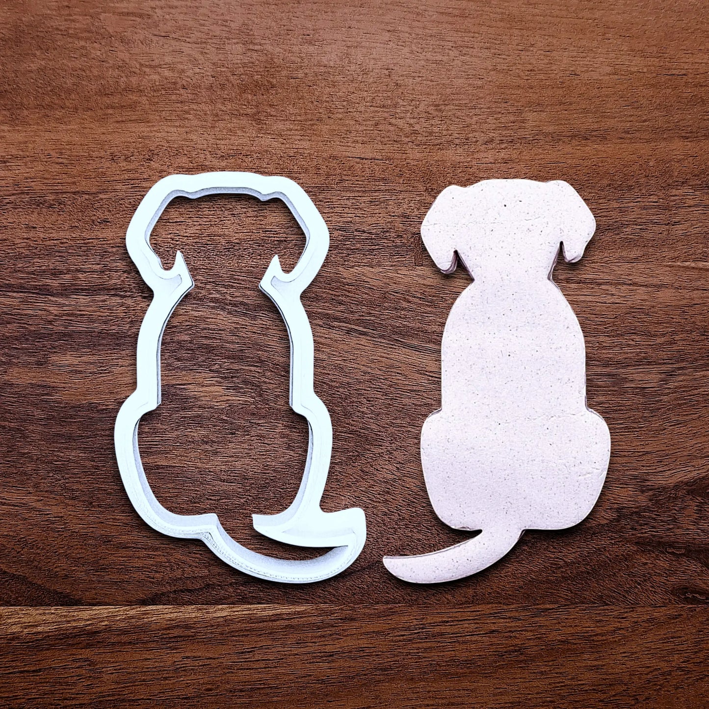 Dog-shaped cookie cutter beside a dough cutout, perfect for pet-themed treats, parties, or homemade dog cookies – eco-friendly and handmade.