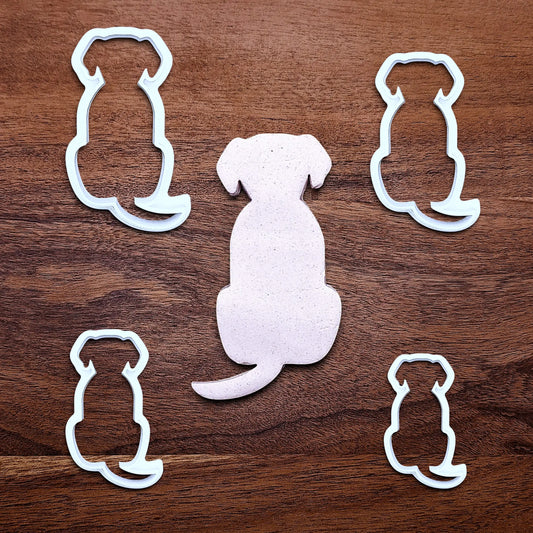 Dog-shaped cookie cutters around a dough cutout, perfect for pet-themed treats, parties, or homemade dog cookies – eco-friendly and handmade.