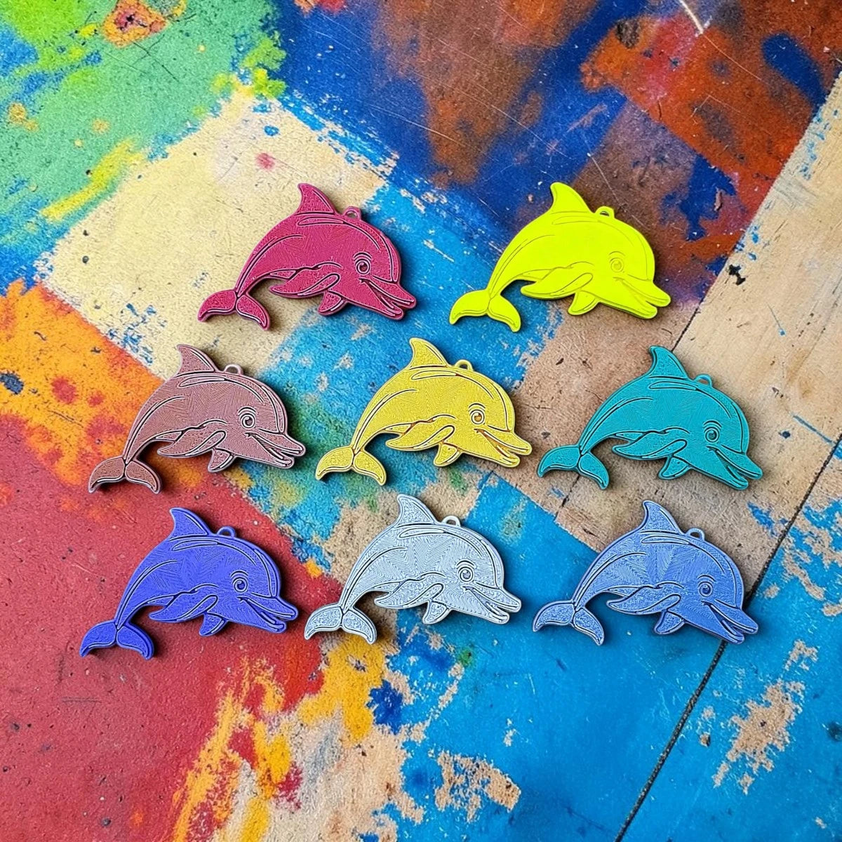 Customizable dolphin keychains in assorted colors, perfect for classroom prizes and beach party favors.