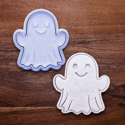 Ghost cookie cutter with stamp alongside dough cutout and imprint – adds spooky face details for Halloween cookies, fondant toppers, or fall baking fun.