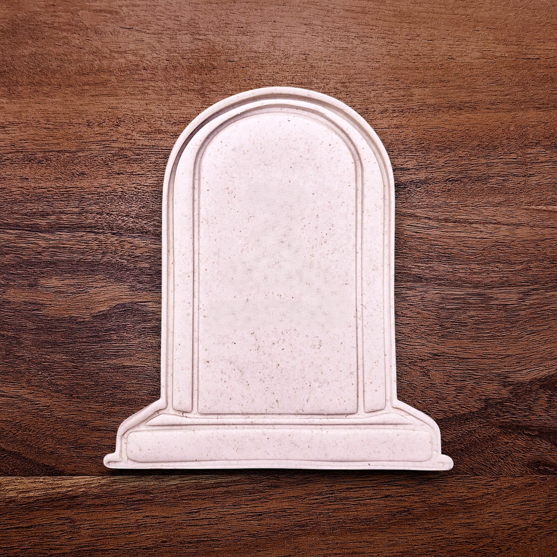 Gravestone cookie dough cutout made with a stamp, perfect for Halloween baking, spooky treats, and themed party desserts.