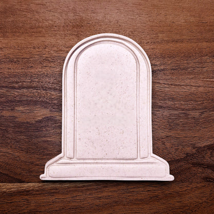 Gravestone cookie dough cutout made with a stamp, perfect for Halloween baking, spooky treats, and themed party desserts.