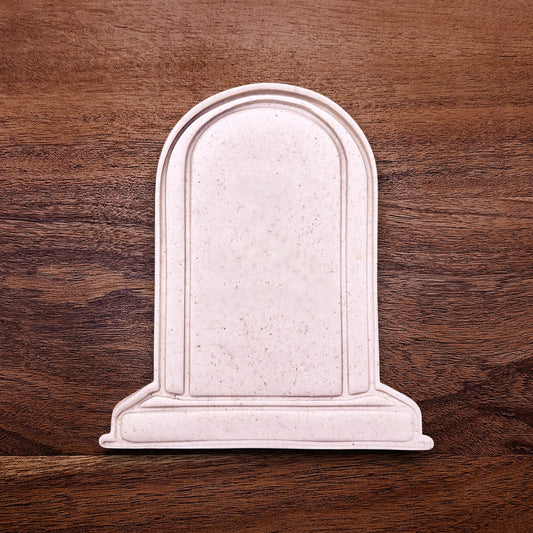 Gravestone cookie dough cutout made with a stamp, perfect for Halloween baking, spooky treats, and themed party desserts.