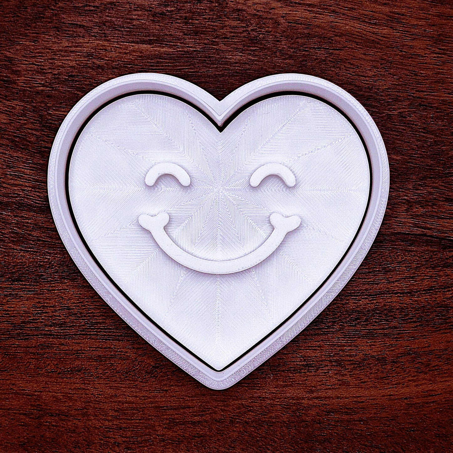 Heart cookie cutter with cheerful face stamp, handmade, food-safe, and eco-friendly for fun, easy baking and party favor creations.