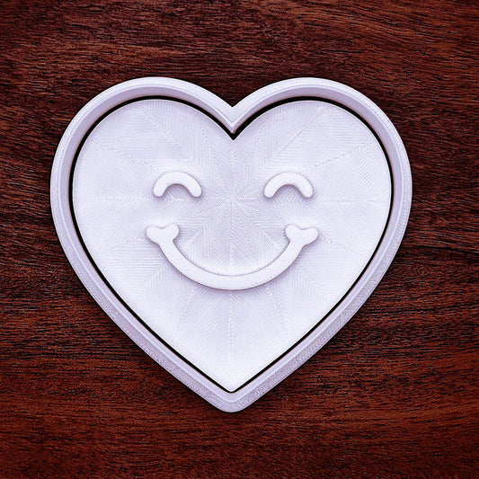 Heart cookie cutter with cheerful face stamp, handmade, food-safe, and eco-friendly for fun, easy baking and party favor creations.