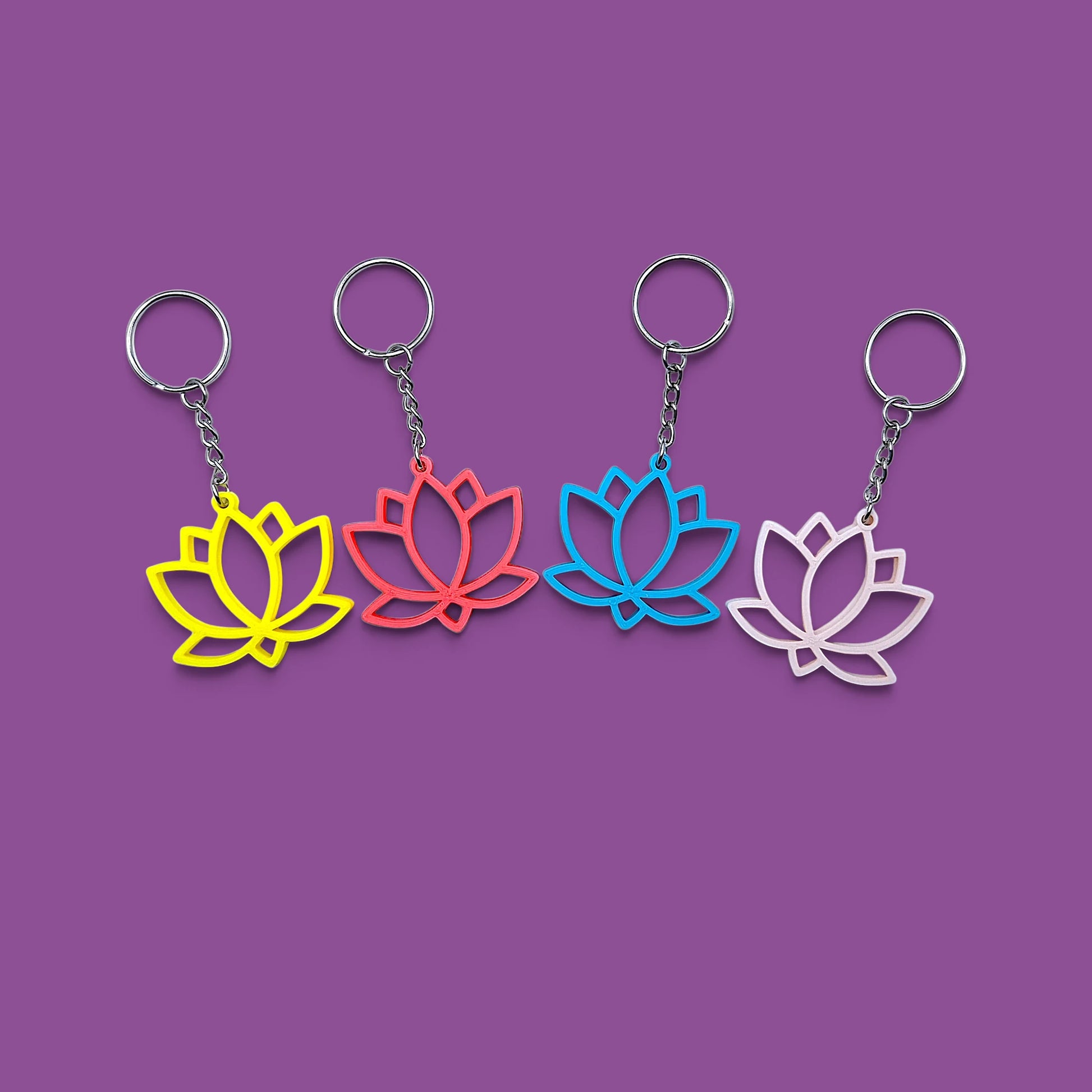 Lotus flower keychains shown in various vibrant colors, eco-friendly and handmade, perfect for spiritual gifts or mindful accessories.