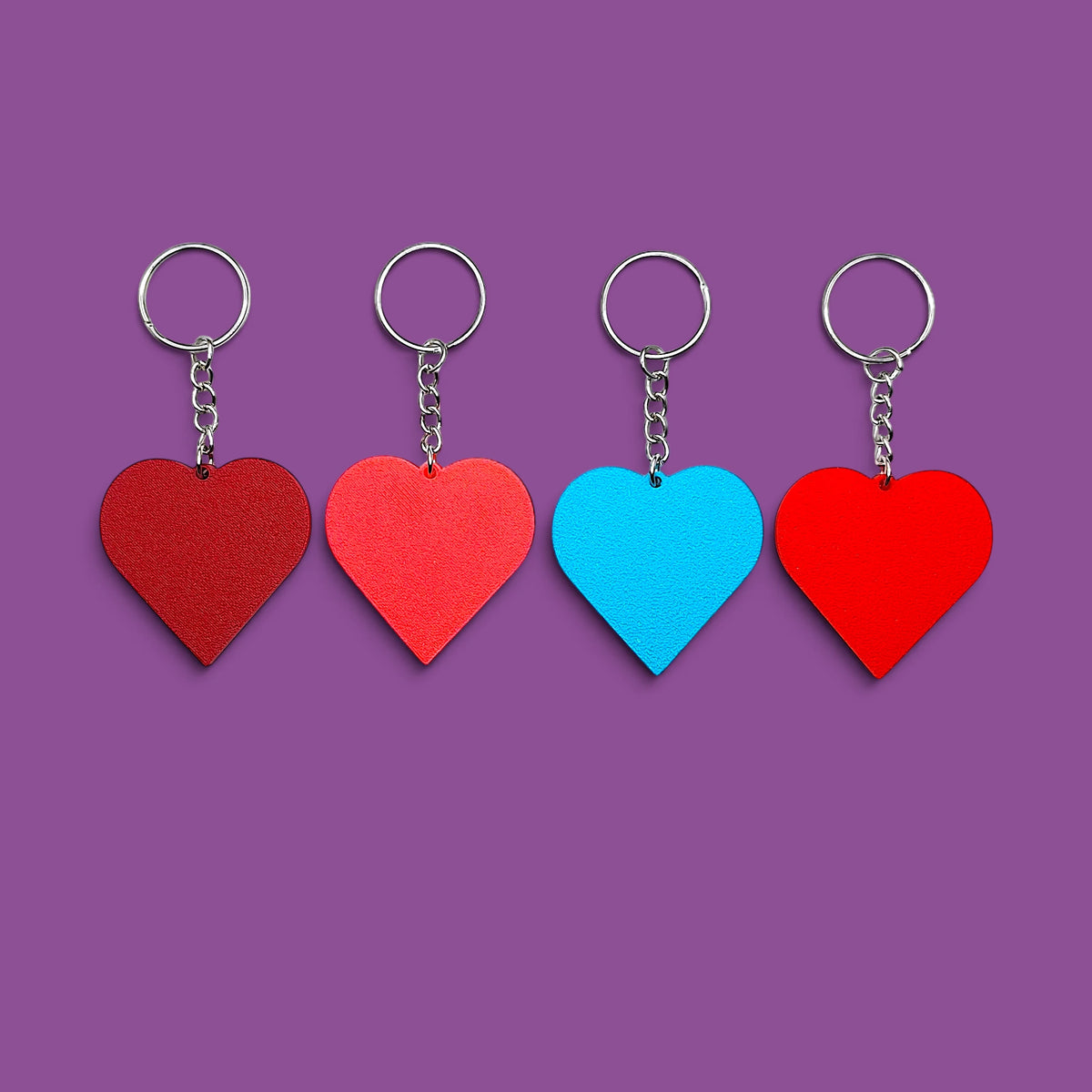 Handmade and customizable heart keychains in assorted colors, perfect for classroom prizes, Valentine's Day gifts, party favors for kids birthdays, baby showers and unique backpack charms.