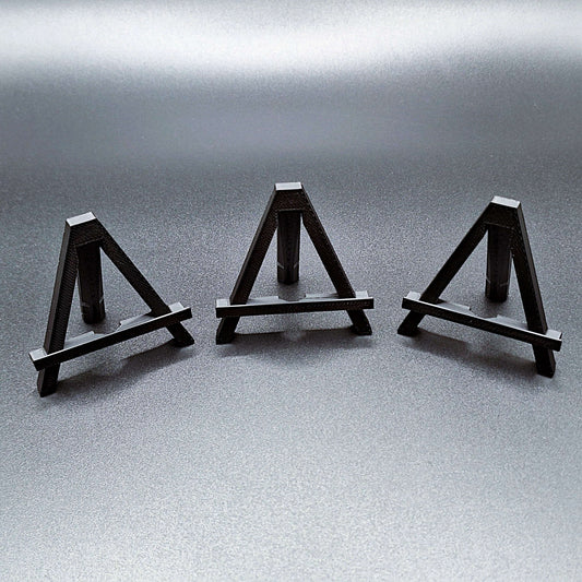 Mini foldable easels in black – compact and portable display stands, perfect for showcasing coins, trading cards, art, photos, or products at craft fairs, markets, and retail displays.