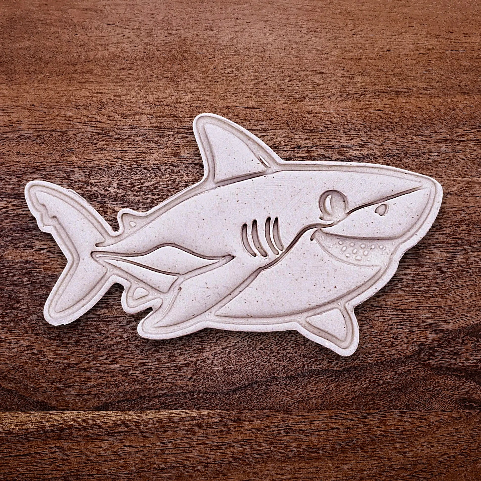 Shark cookie dough cutout with stamped fin and face detail. Perfect for beach parties, ocean birthdays, and kid-friendly shark bakes.