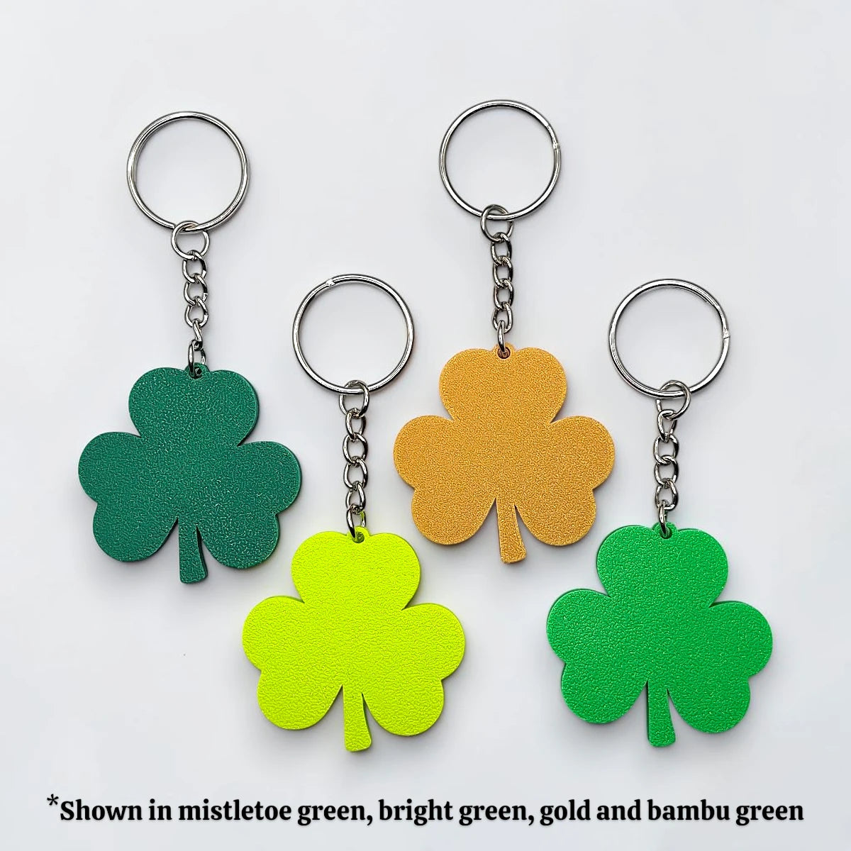 Handmade and customizable shamrock clover keychains with silver keyrings, perfect for St Patrick's Day party favors and gifts.
