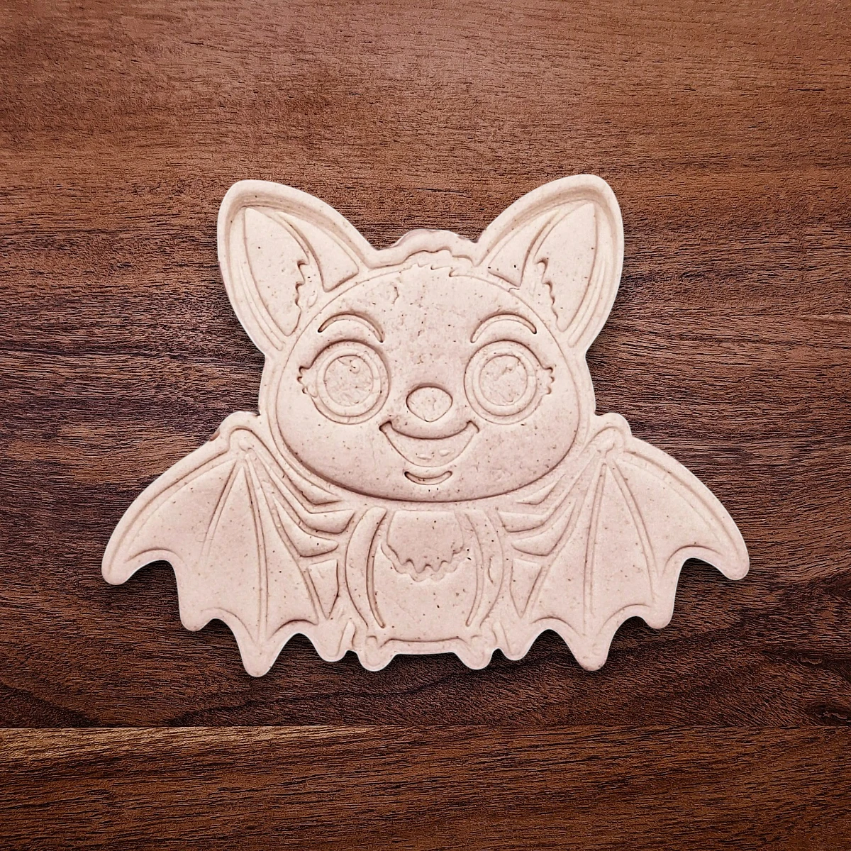 Stamped cute bat cookie dough with cute details from cutter and stamp set—perfect for cute and spooky Halloween bakes without the need for piping.