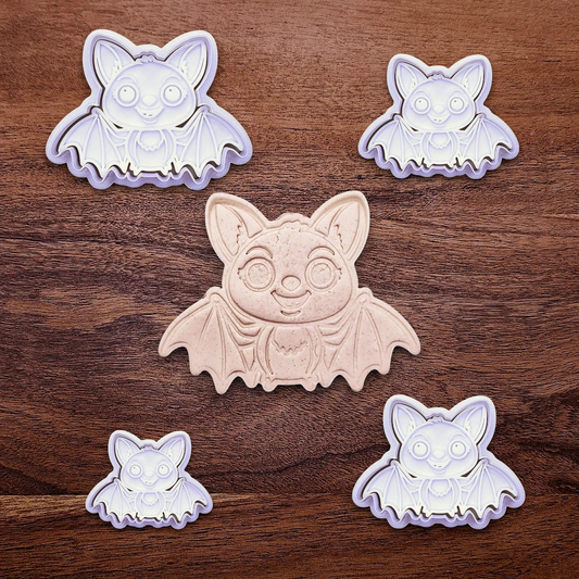 Cute bat cookie cutters with stamps alongside a dough cutout and imprint - adds cute Halloween charm, complete with cute details for whimsical baking, parties, or spooky gifting. Handmade and customizable in 30 colors.