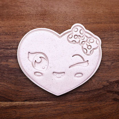 Heart cookie cutter dough cutout with smiley face imprint, perfect for Valentine’s Day cookies, wedding favors, and fun DIY baking projects.