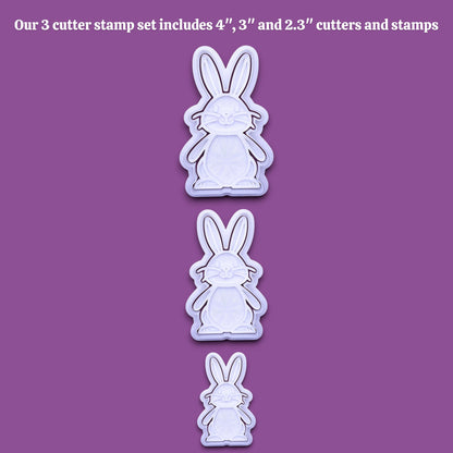 Three bunny-shaped cookie cutters and stamps shown in descending size order on a solid purple background, with white text at the top stating 'Our 3 cutter stamp set includes 4", 3", and 2.3" cutters and stamps'.