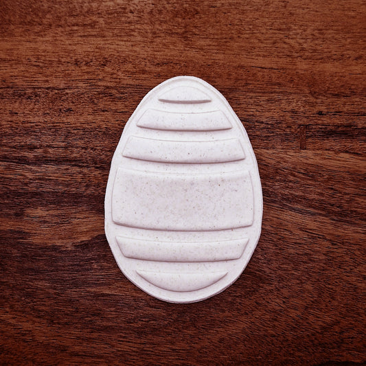 Easter egg dough imprint made with matching stamp—shows clean lines and festive design, ideal for no-fuss cookie decorating.