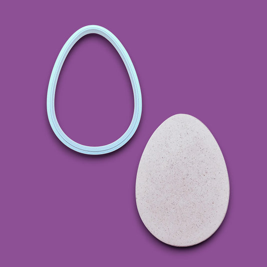 Egg Cookie Cutter  alongside a dough cutout – Oval-shaped baking tool for cookies, fondant, sandwiches, and crafts, available in multiple sizes and vibrant colors.