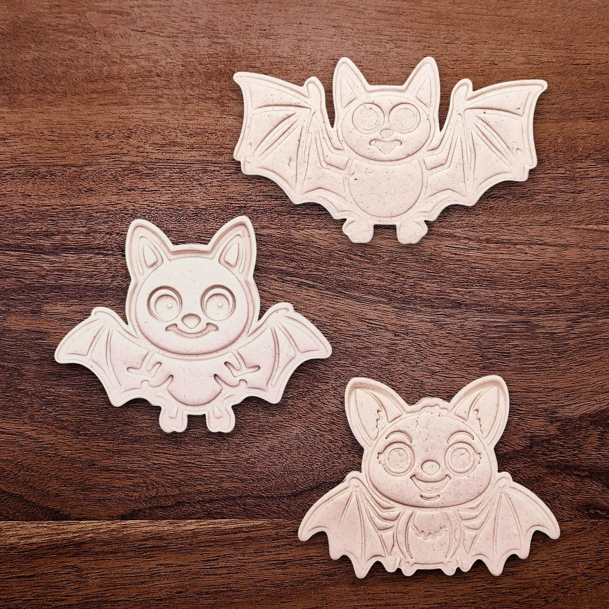Bat cookie cutter dough cutouts and imprints, perfect for Halloween treats, fall party favors, and gifting. Customizable in 30 unique colors and made from eco-friendly materials.