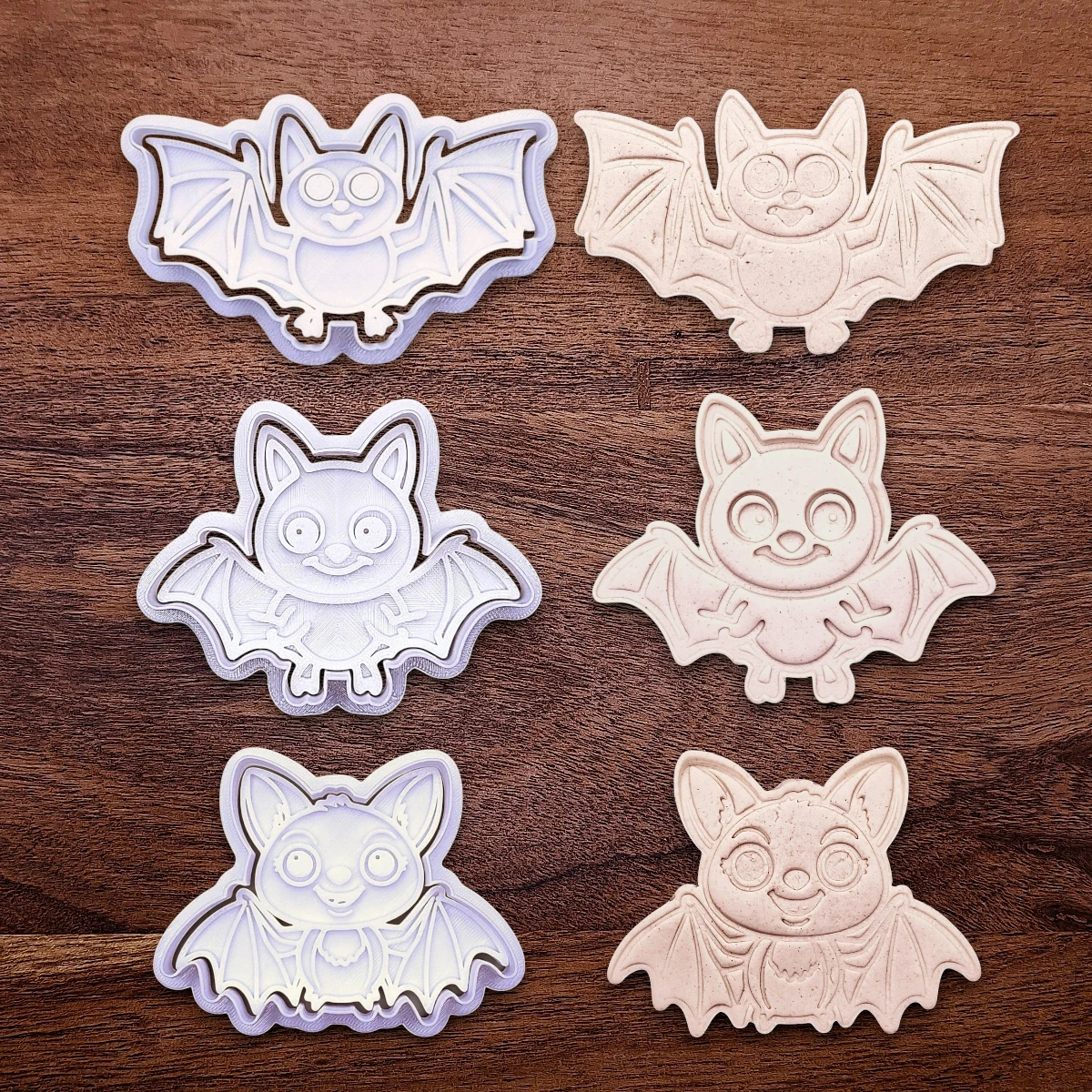 Bat cookie cutters and stamps alongside dough cutouts and imprints, perfect for Halloween treats, fall party favors, and gifting. Customizable in 30 unique colors and made from eco-friendly materials.