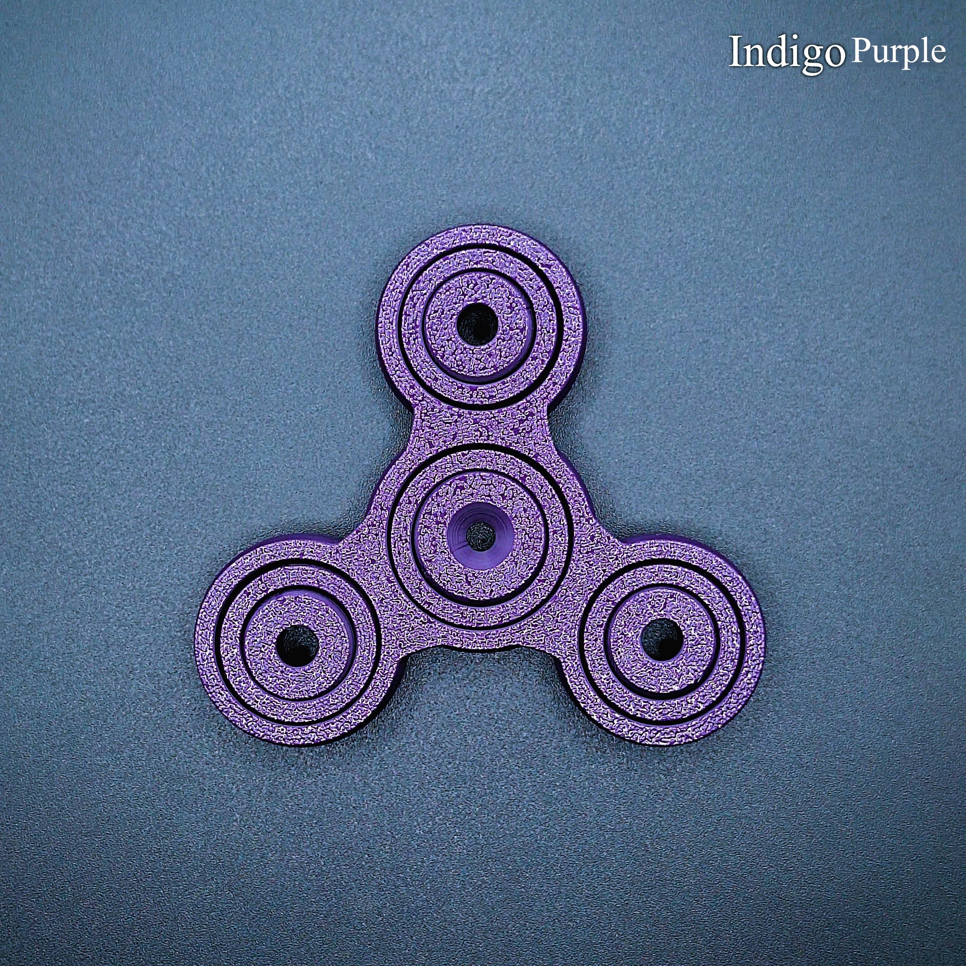 Indigo purple 3" fidget spinner with triple-prong design—perfect sensory tool for stress relief, focus, and calm. Durable, biodegradable, handmade.