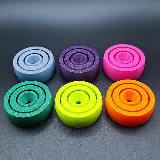 Front view of six smooth-surfaced fidget spinners in assorted colors, great for tactile calming, fidgeting, and mental focus.