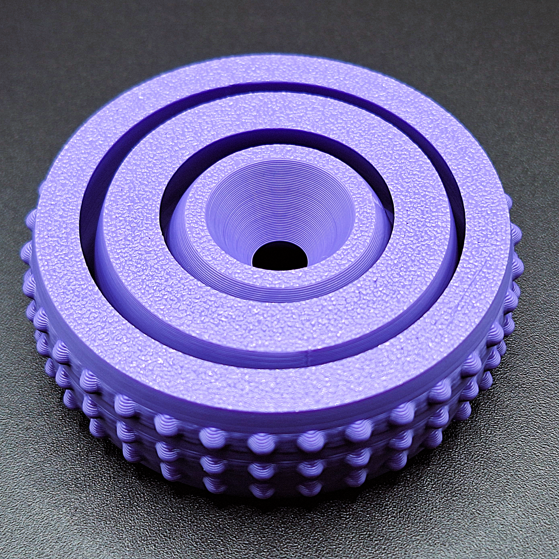 Top-down view of modern fidget spinner model, featuring rounded design and smooth center for easy spinning and stress relief in 3 sizes.