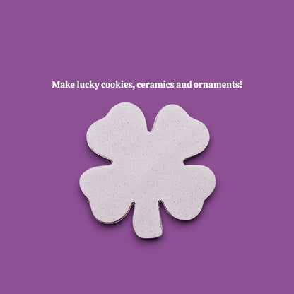 A single four-leaf clover-shaped dough cutout make from a shamrock cookie cutter.
