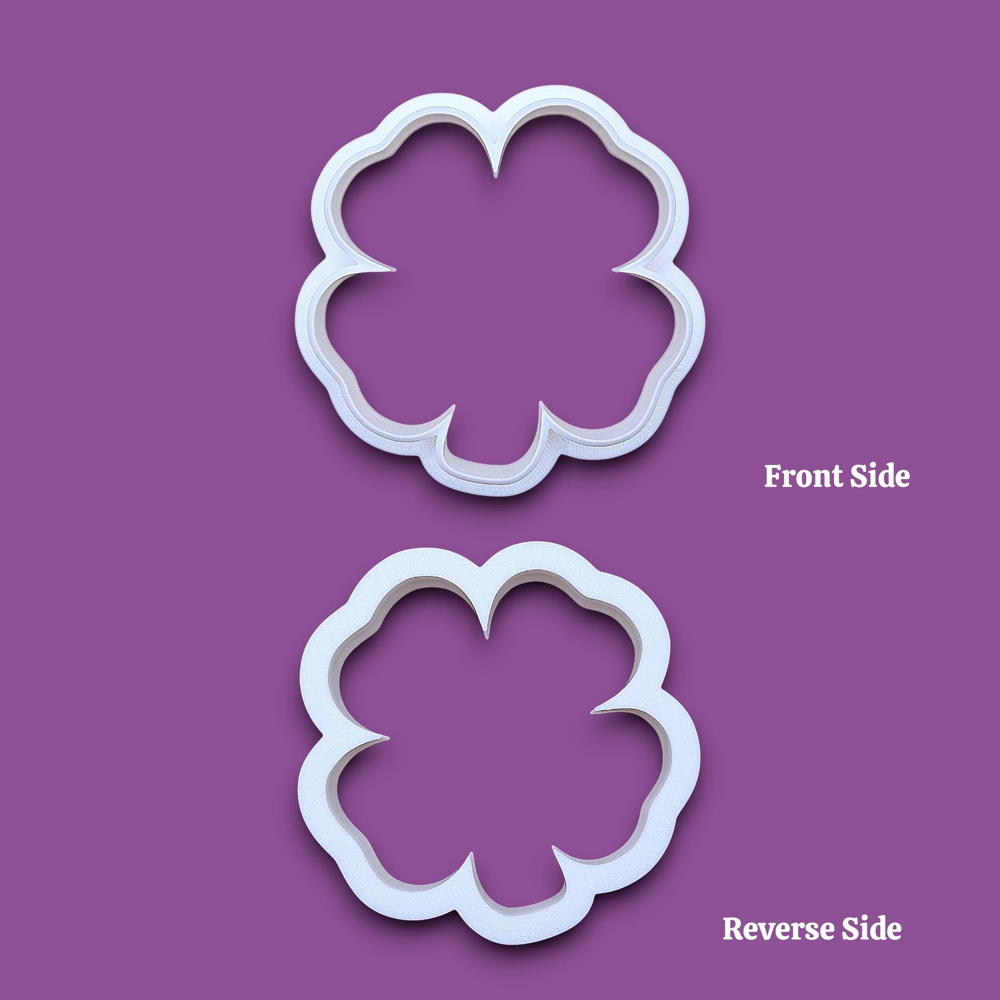 A white four leaf clover cookie cutter, shown on front and reverse.