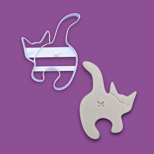 Cat butt cookie cutter alongside a dough cutout and imprint, perfect for gag gifts, funny treats and white elephant parties.