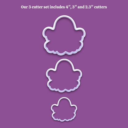 Three white ghost-shaped cookie cutters of decreasing sizes displayed vertically on a solid purple background, with white text at the top stating 'Our 3 cutter set includes 4", 3", and 2.3" cutters'.