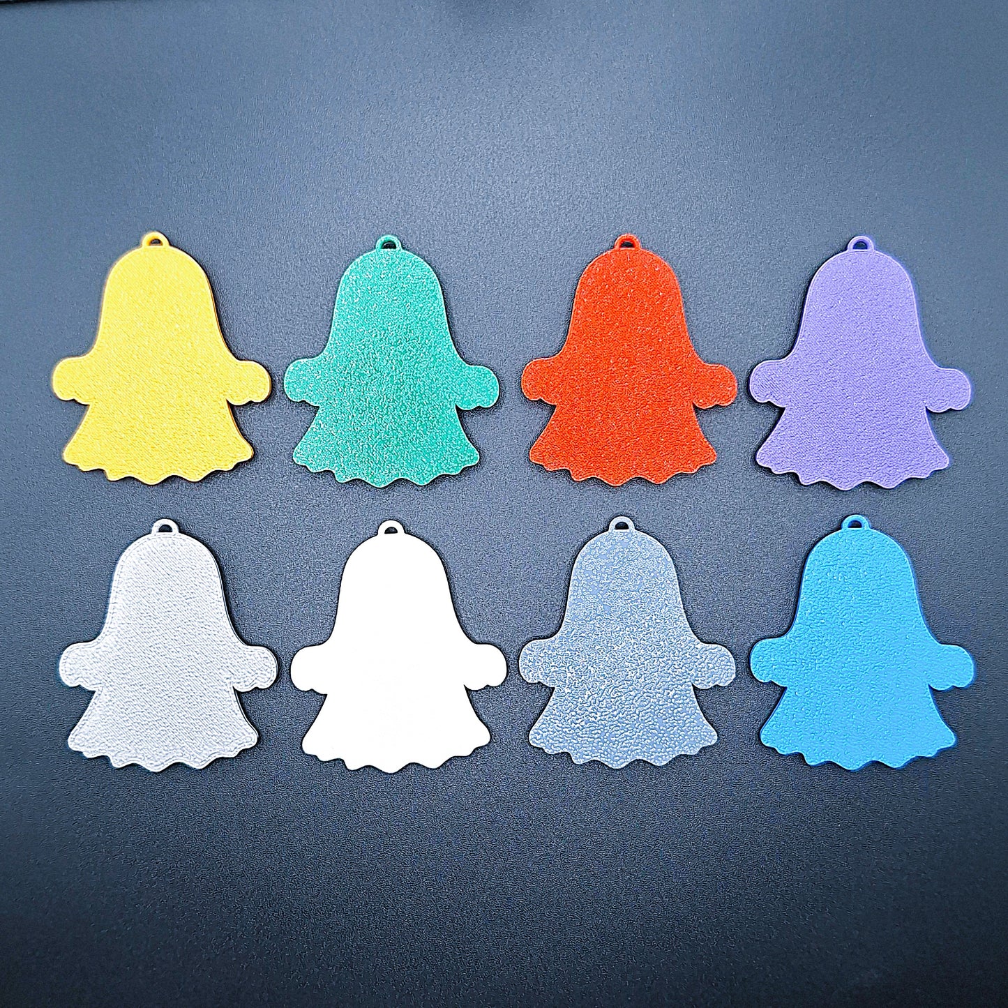 Back view of eight happy ghost keychains in 8 colors, cute Halloween key ring set, handmade eco-friendly spooky bag charms for trick-or-treat or gifts.