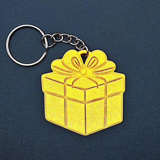 Gold gift box keychain—shiny, festive charm made from eco PLA plastic; great for Christmas gifts, birthday favors, or stylish bag accessories.