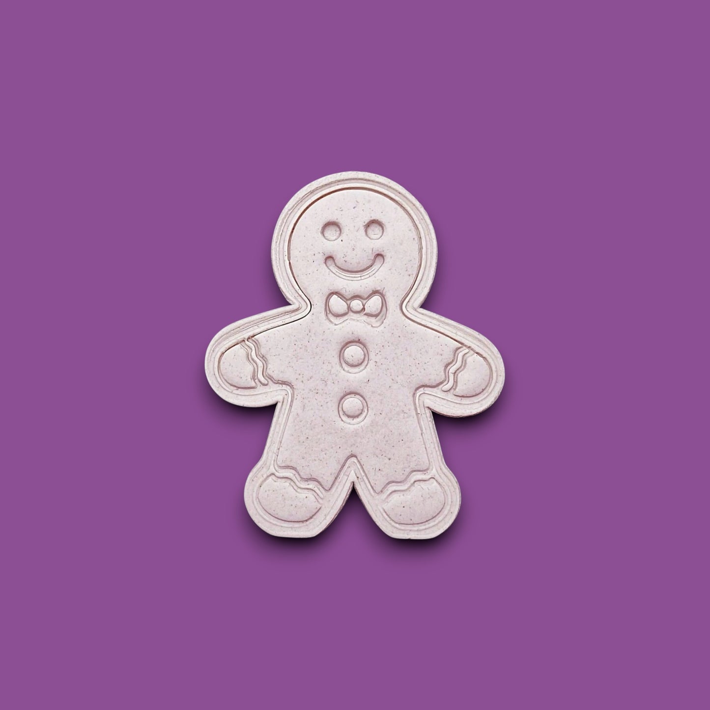 Holiday dough cutout with stamped gingerbread man design, ideal for Christmas cookies, fondant decorating, and festive baking with no piping needed.