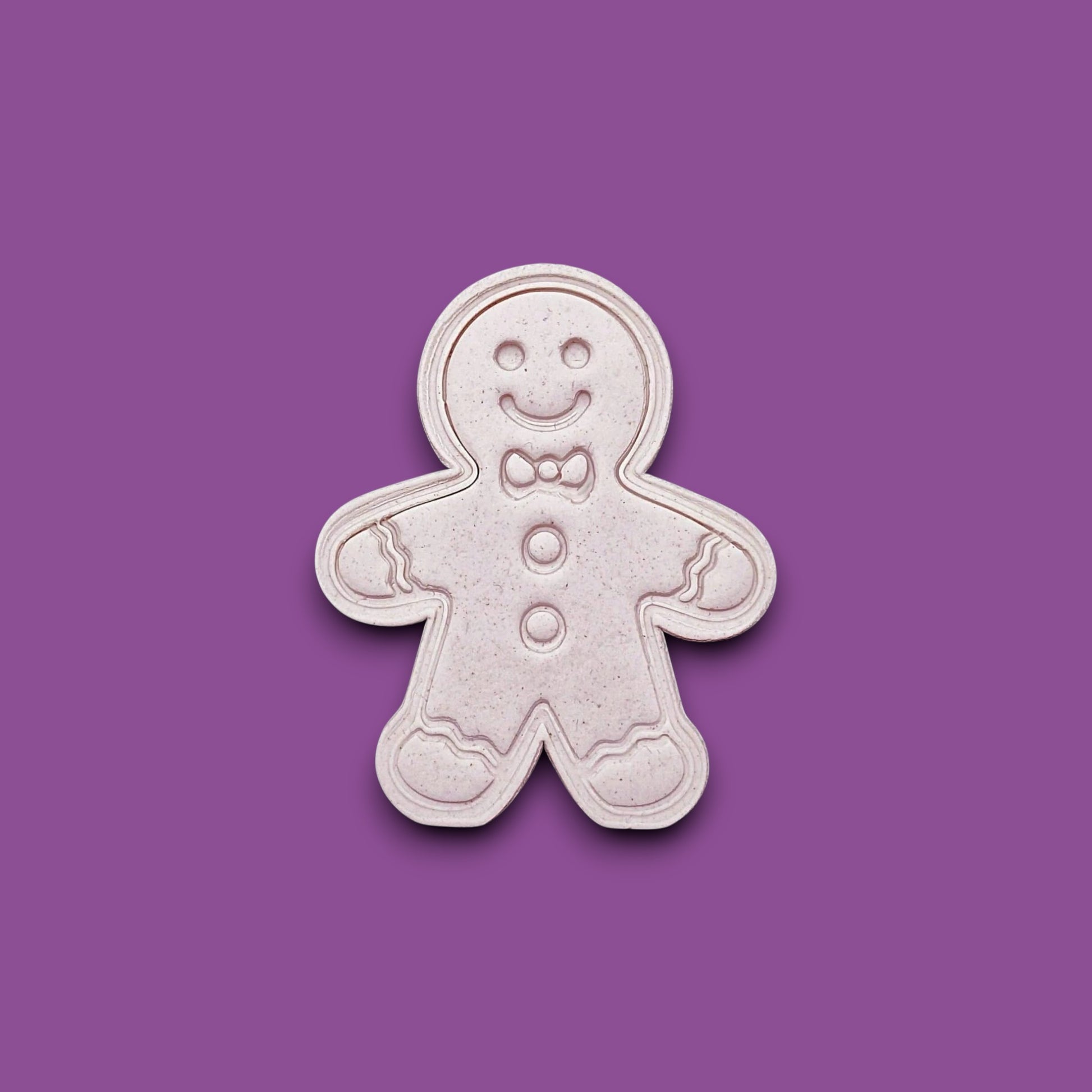 Holiday dough cutout with stamped gingerbread man design, ideal for Christmas cookies, fondant decorating, and festive baking with no piping needed.