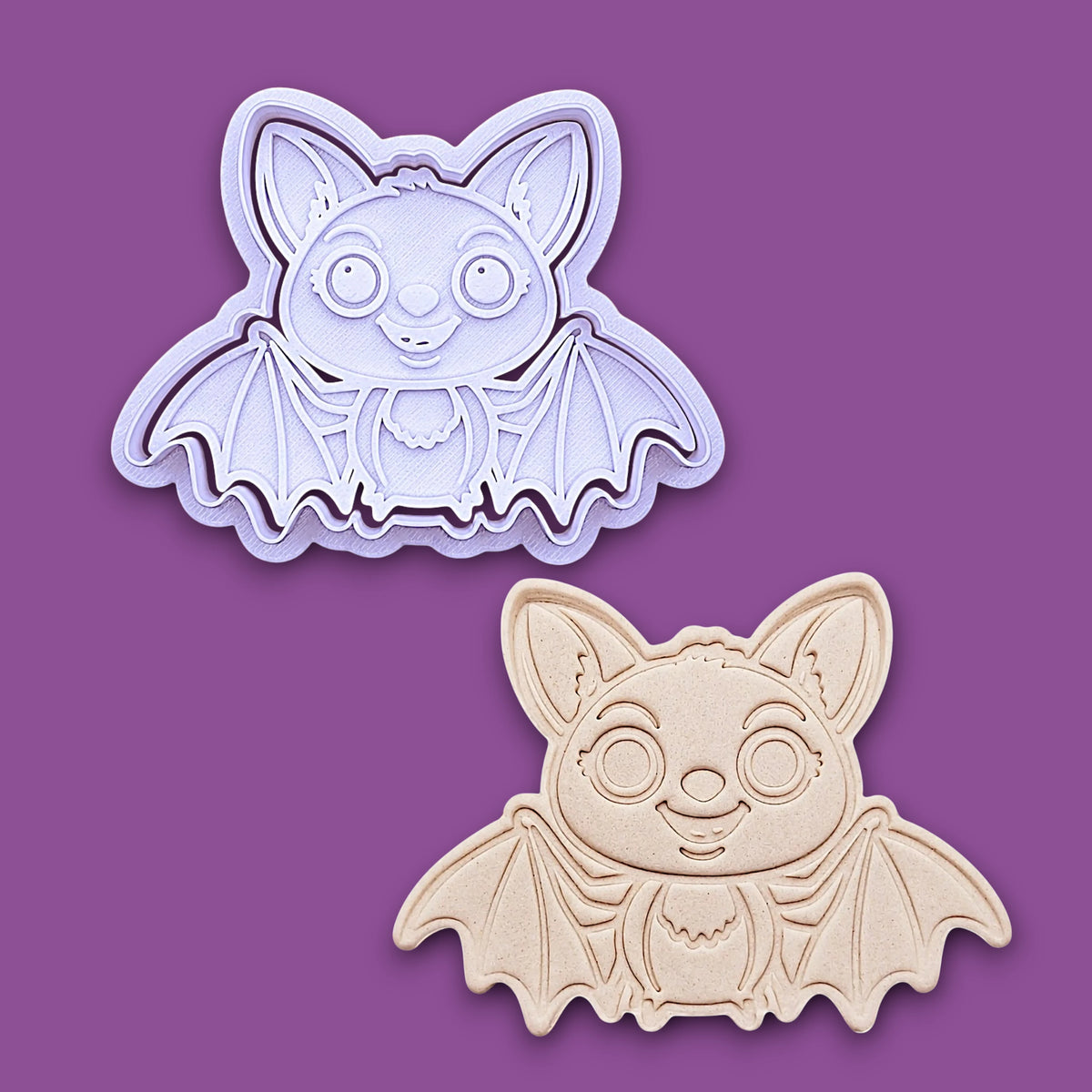 Cute bat cookie cutter with stamp alongside a dough cutout and imprint - adds cute Halloween charm, complete with cute details for whimsical baking, parties, or spooky gifting. Handmade and customizable in 30 colors.